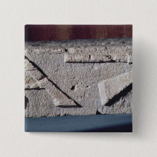Relief depicting a stonemason's instrument 15 cm square badge