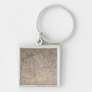 Relief depicting the unloading of wood key ring