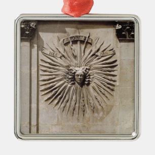 Relief of the sun from the facade metal ornament