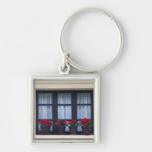 Residential housing with flowers in windows key ring