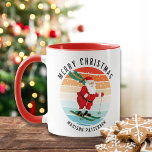 Retro Christmas Sunset Skiing Santa Personalised Mug<br><div class="desc">Retro Christmas Sunset Skiing Santa Personalised Mugs features an illustration of a retro Santa Claus skiing down a hill at sunset with the text "Merry Christmas" in modern typography and personalised with your family name. Personalise by editing the text in the text boxes provided. Designed by ©Evco Holidays www.zazzle.com/store/evcoholidays</div>