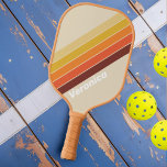Retro Striped with Name Pickleball Paddle<br><div class="desc">Retro Stripes Pickleball Paddle, a perfect blend of classic style and modern performance. This paddle is designed to evoke a sense of nostalgia while delivering exceptional playability on the pickleball court. With its retro-inspired stripes pattern, this paddle captures the essence of vintage aesthetics. The clean lines and bold colours create...</div>