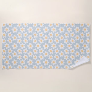 Retro style daisies in bloom on blue background beach towel