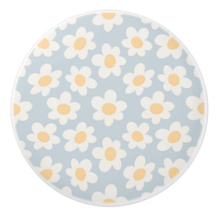 Retro style daisies in bloom on blue background ceramic knob