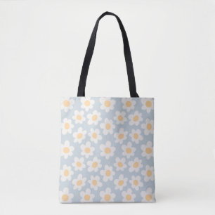 Retro style daisies in bloom on blue background tote bag