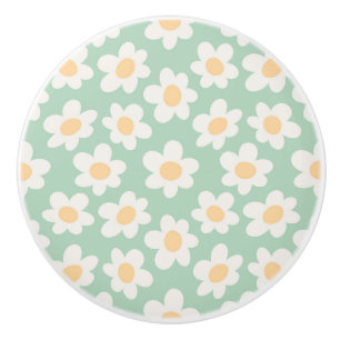 Retro style daisies in bloom on green background ceramic knob