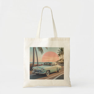 Retro-style vintage car on a coastal road tote bag