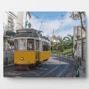 Retro yellow tram on street in Lisbon, Portugal Plaque