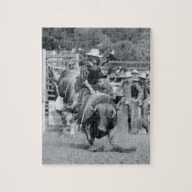 Rider hanging on to bucking bull jigsaw puzzle (Vertical)