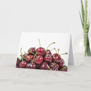 ripe red cherry pile on white card