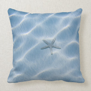 Rippled blue water with starfish cushion