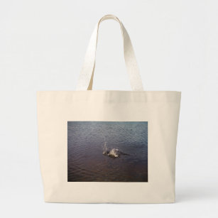 Ripples in a lake, from a fish jumping large tote bag
