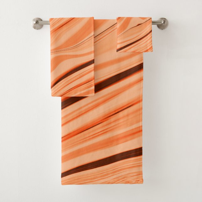 Ripples in shades of orange, curved brown cylinder bath towel set (Insitu)