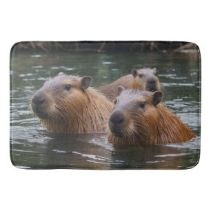 "River Serenity: Capybaras Swimming in the Flow" Bath Mat