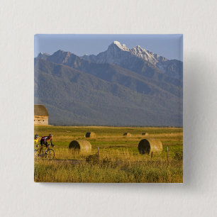 Road bicyclists race down back country road in 15 cm square badge