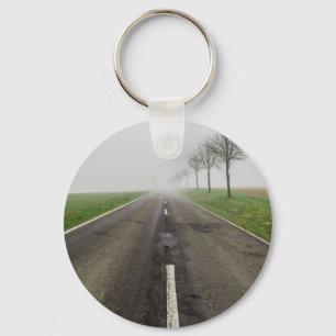 Road in fog leads to nothing key ring