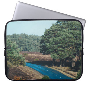 ROAD SURROUNDED WITH TREE DURING DAYTIME LAPTOP SLEEVE