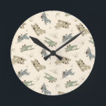Roaring Art Deco Bi-planes - blue green pattern.   Round Clock<br><div class="desc">Fun tossed kids aviation pattern of hand-drawn bi-planes in 1920's Art Deco colors,  set on a solid cream background. This is a transparent pattern. You can change the background color and the size and position of the pattern. This design matches the Art Deco Bi-planes collection.</div>