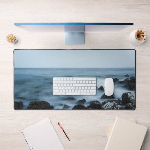 Rocky shore with misty water desk mat