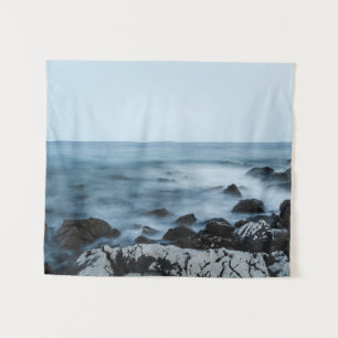 Rocky shore with misty water tapestry