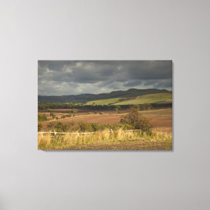 Rolling Hills And Mountains Under A Cloudy Sky Canvas Print