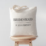 Roman Numeral Date Bridesmaid Bridal Party Tote Bag<br><div class="desc">These modern minimalist wedding tote bags make great bridal party gifts. Clean minimal design features "bridesmaid" or your choice of role,  and your wedding date in modern black serif lettering,  bisected by a single line. Your wedding date in roman numerals adds a chic touch.</div>
