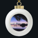 Romantic Maldives Tropical Sunset Ceramic Ball Christmas Ornament<br><div class="desc">This beautiful round ornament is decorated with a sunset image of Maldives in one of the remote islands with a palm tree in the foreground. There is a row of water bungalows and a gondola in the background bathing in the glow of the setting sun.</div>