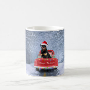 Rottweiler Dog in Snow sitting in Christmas Truck Coffee Mug