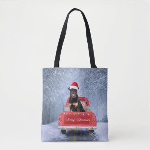 Rottweiler Dog in Snow sitting in Christmas Truck Tote Bag