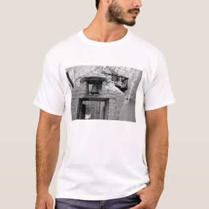 Rough adobe bell in entryway, Santa Fe, New T-Shirt