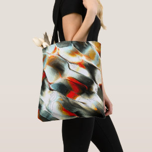 Rough silvery rock over burning ember, intensity tote bag