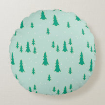 Round cushion with tree and snow design.