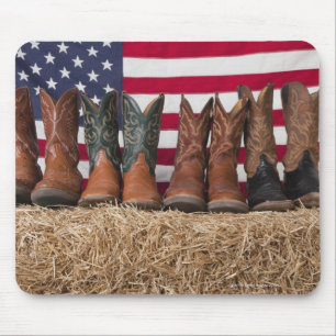 Row of cowboy boots on haystack mouse pad
