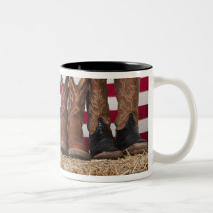 Row of cowboy boots on haystack Two-Tone coffee mug