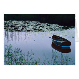 Rowboat on small lake surrounded by water