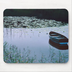 Rowboat on small lake surrounded by water mouse pad