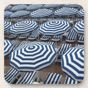 Rows Of Striped Beach Umbrellas With Sun Beds Coaster