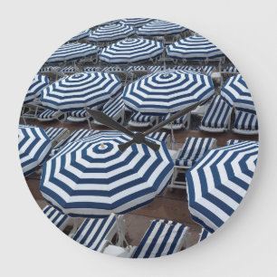 Rows Of Striped Beach Umbrellas With Sun Beds Large Clock