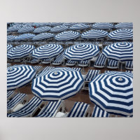 Rows Of Striped Beach Umbrellas With Sun Beds