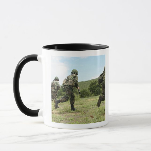Royal Thai Marines rush forward to secure the s Mug (Left)
