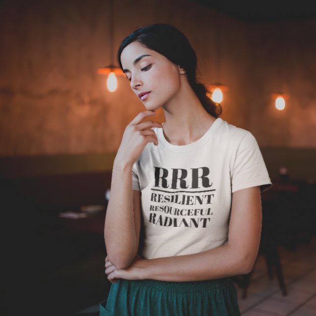 RRR- Resilient, Resourceful, Radiant T-Shirt (Young woman in thoughtful pose wearing a "RRR: Relilient, Resourceful, Radiant" white t-shirt.)