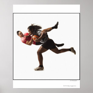 Rugby players tackling for ball poster