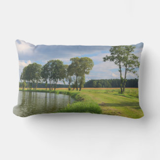 Rural landscape with trees, water and cloudy sky lumbar cushion