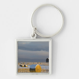 Rustic barn and hay bales after a fresh snow 3 key ring