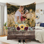 Rustic Sunflower Wedding Couple Photo Fleece Blanket<br><div class="desc">This rustic sunflower and burgundy roses country wedding couple photo blanket makes a perfect gift. This blanket features watercolor yellow sunflowers with burgundy roses and baby's breath and sage greenery on a wood background. This is a perfect colour scheme for a late summer or fall wedding. Personalise with names and...</div>