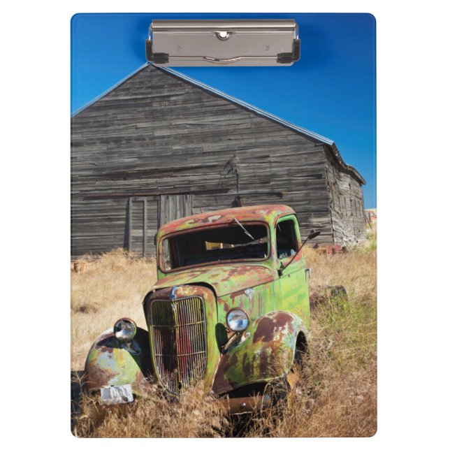 Rusting car in front of abandoned farm clipboard (Front)