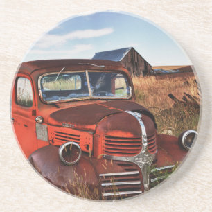 Rusting orange Dodge truck with abandoned farm Coaster