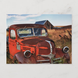 Rusting orange Dodge truck with abandoned farm Postcard