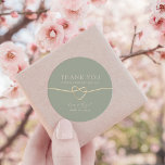 Sage Green Gold Heart Wedding Thank You Classic Round Sticker<br><div class="desc">Thank your guests in style with this elegant round wedding sticker featuring a soft sage green background, romantic gold rope heart, and personalised names and date. Ideal for sealing favour boxes, envelopes, or gift bags, this design complements rustic, minimalist, spring, or botanical-themed weddings. Fully customisable and perfect for couples who...</div>