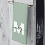 Sage Green Name Monogram Tea Towel<br><div class="desc">Custom Sage Green Monogram Name Kitchen Towel. Add a stylish personal touch to your kitchen with this elegant towel design. The background is a soft sage green, paired with crisp white lettering for the initial and a bold black name in flowing script across the front. Designed for a tri-fold display,...</div>